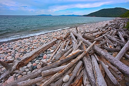 Canada-Ontario-Marathon Rocks and driftwood on Pebble Lake Superiors Beach Art Print